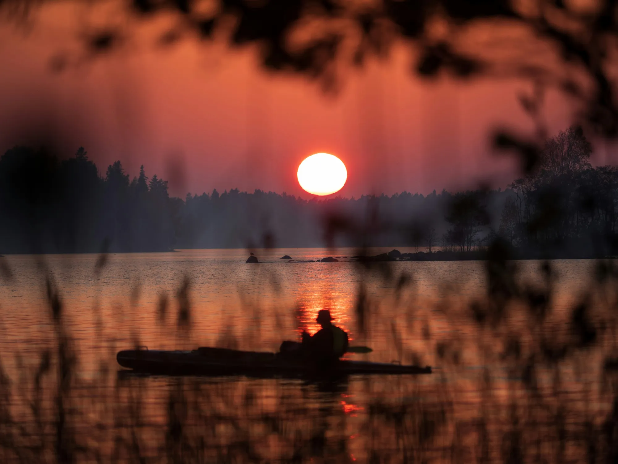 Kayakers paddling on a lake in North Karelia
